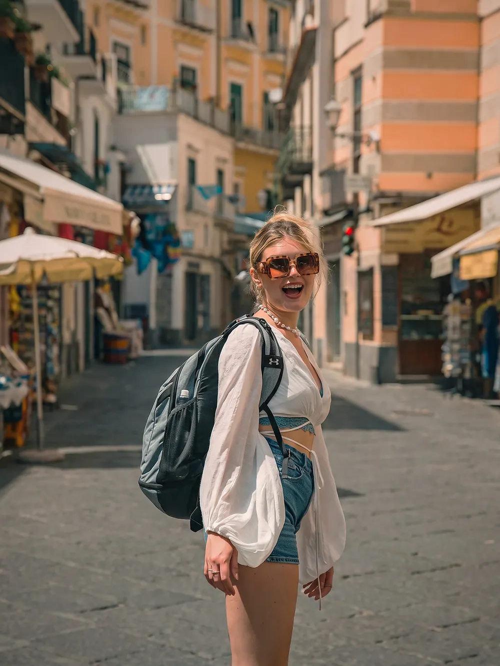 The same photo after ClearShot Keep one: only the woman remains and the street behind her is empty