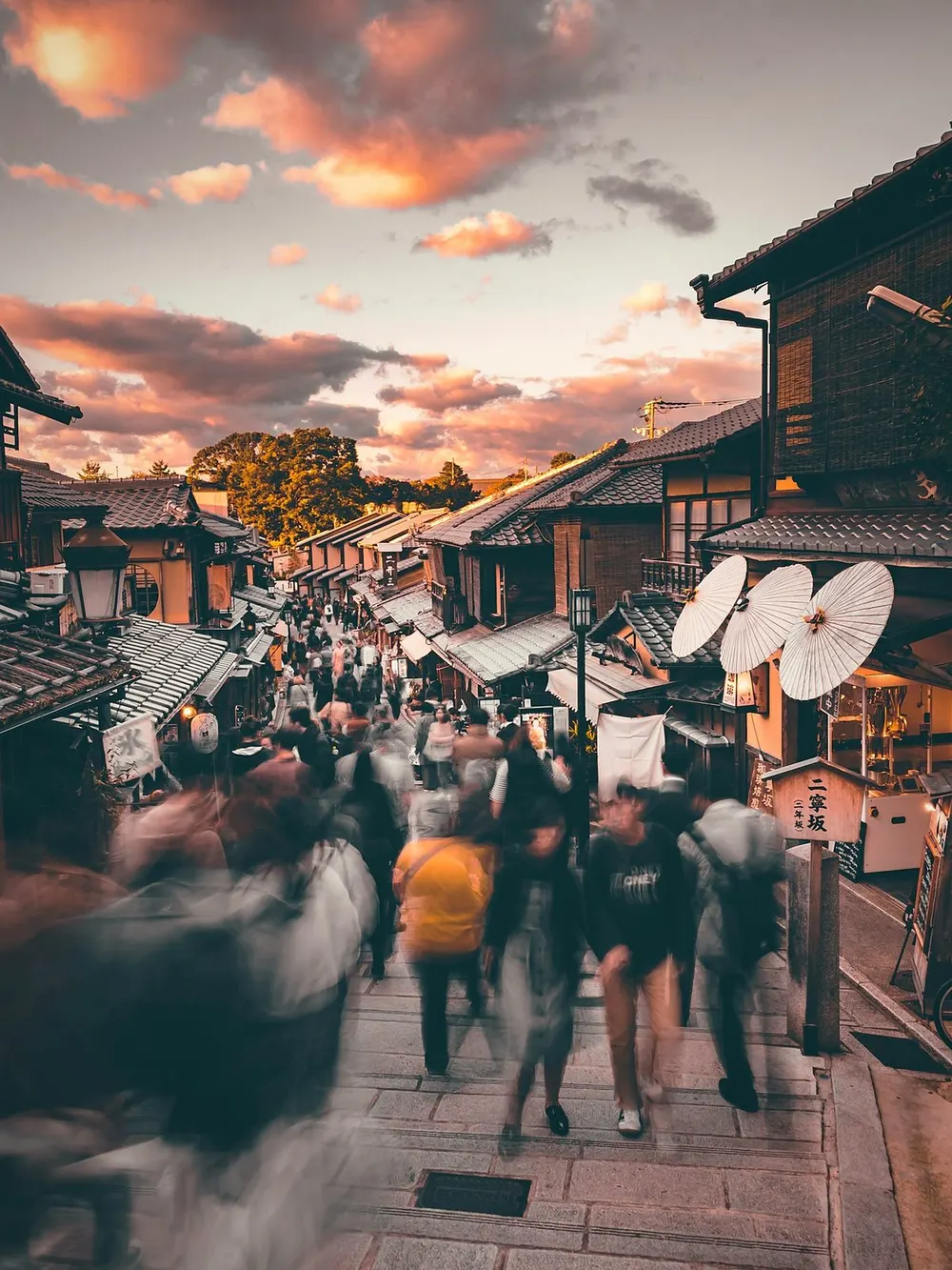 Ninenzaka street in Kyoto at sunset, crowded with blurred tourists